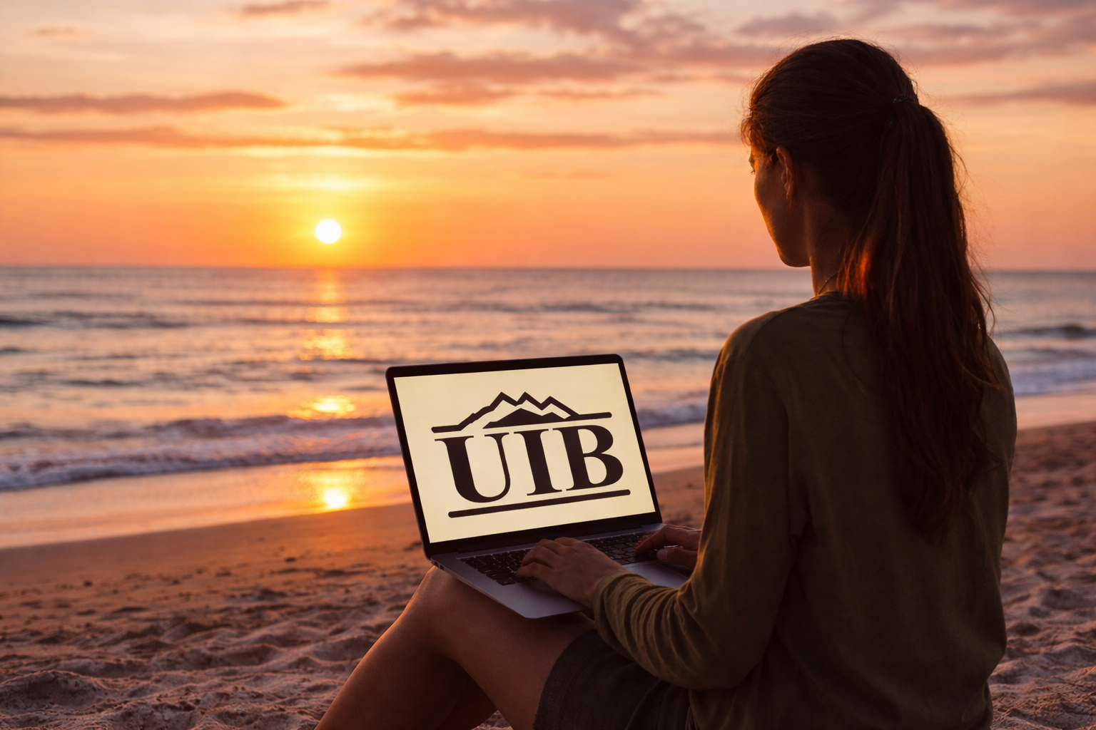 A woman on a laptop at the beach